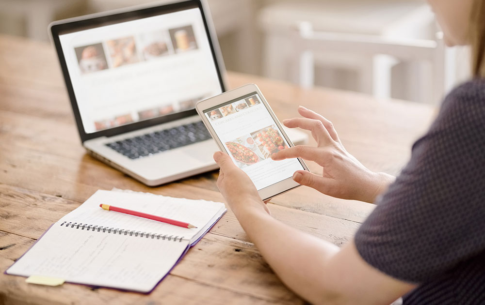 Person Looking At A  Blog On A  Tablet Device