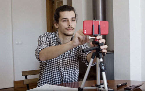 Young Man Setting Up His Phone to Livestream